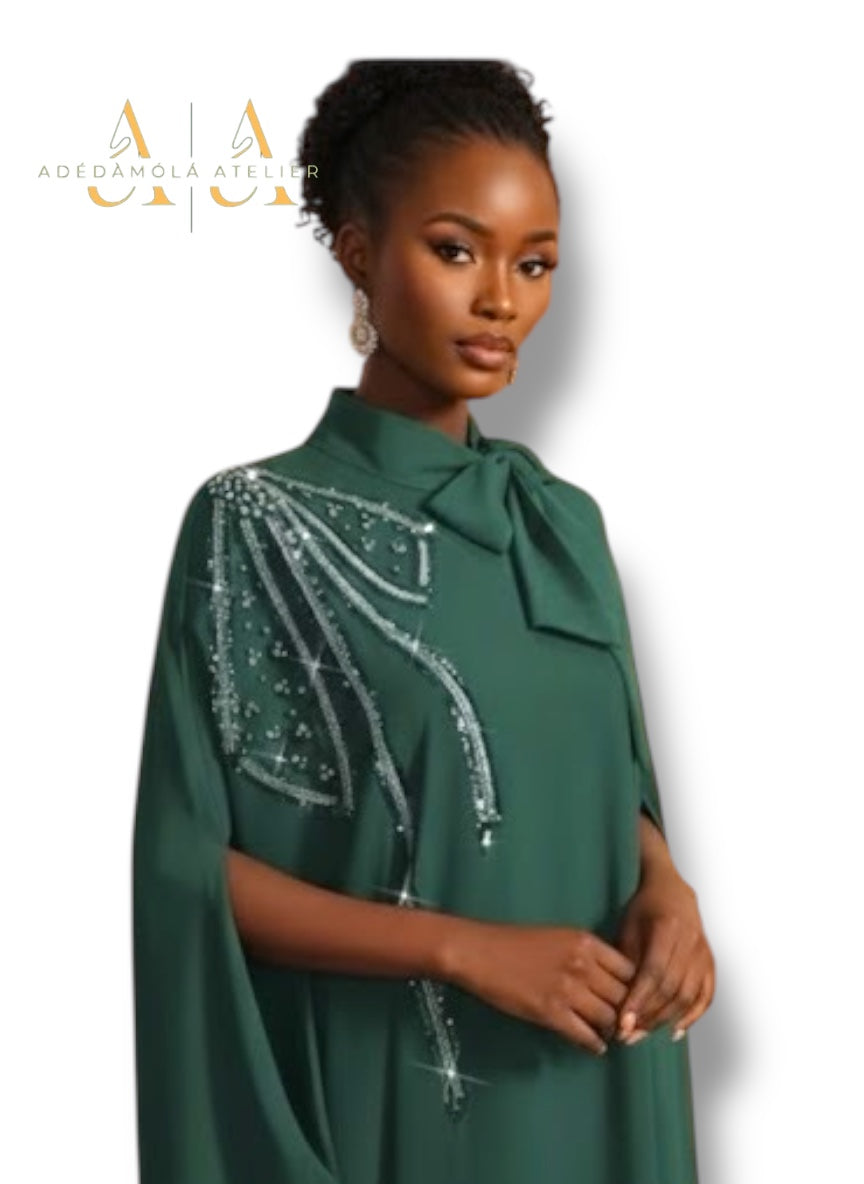 Woman wearing a green dress with silver embellishments on a white background