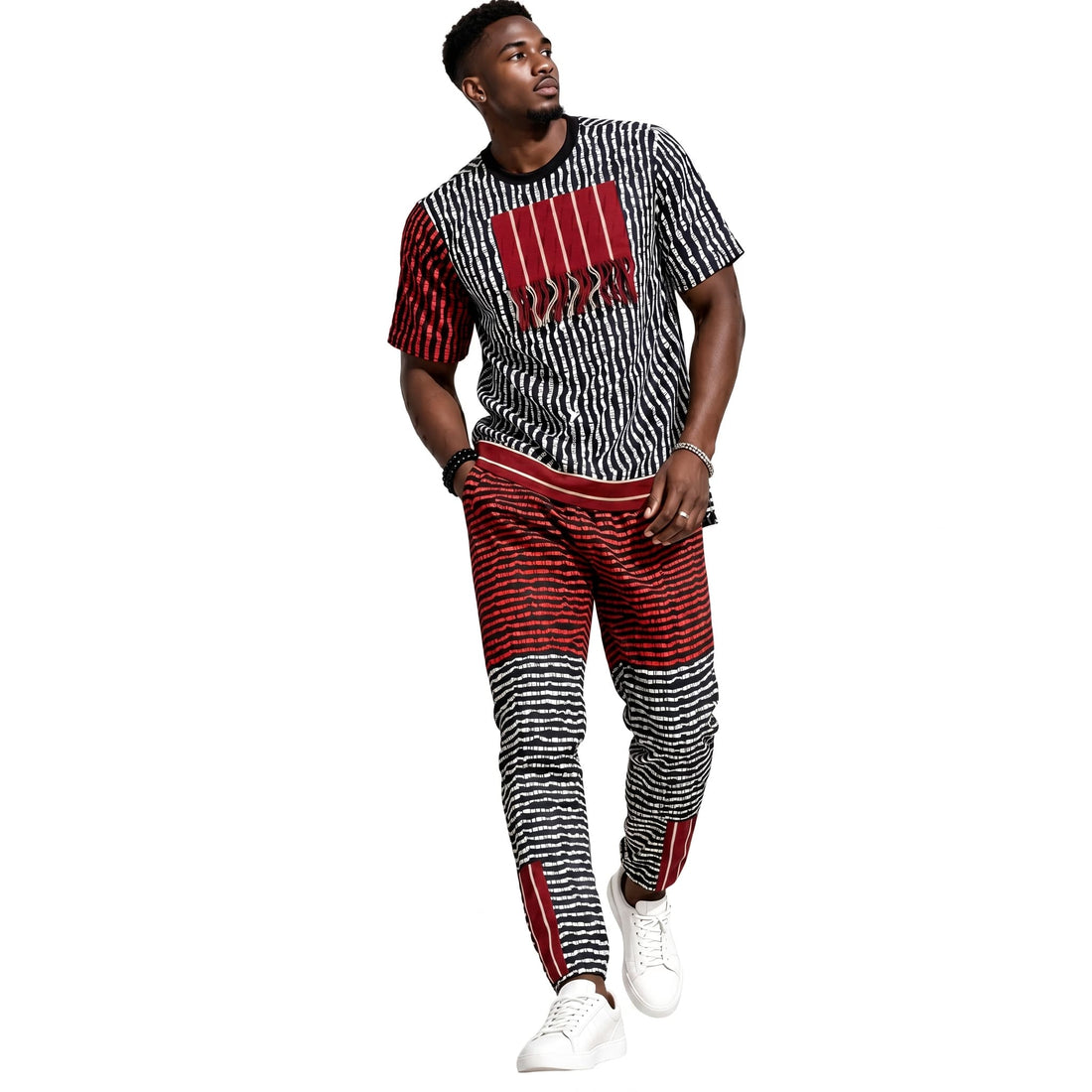 Man wearing a black and white patterned outfit with red accents on a white background