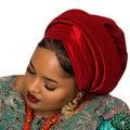 Woman wearing a red headscarf and colorful traditional outfit on a white background