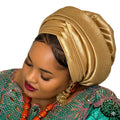 Woman wearing a gold headscarf and colorful traditional outfit on a white background