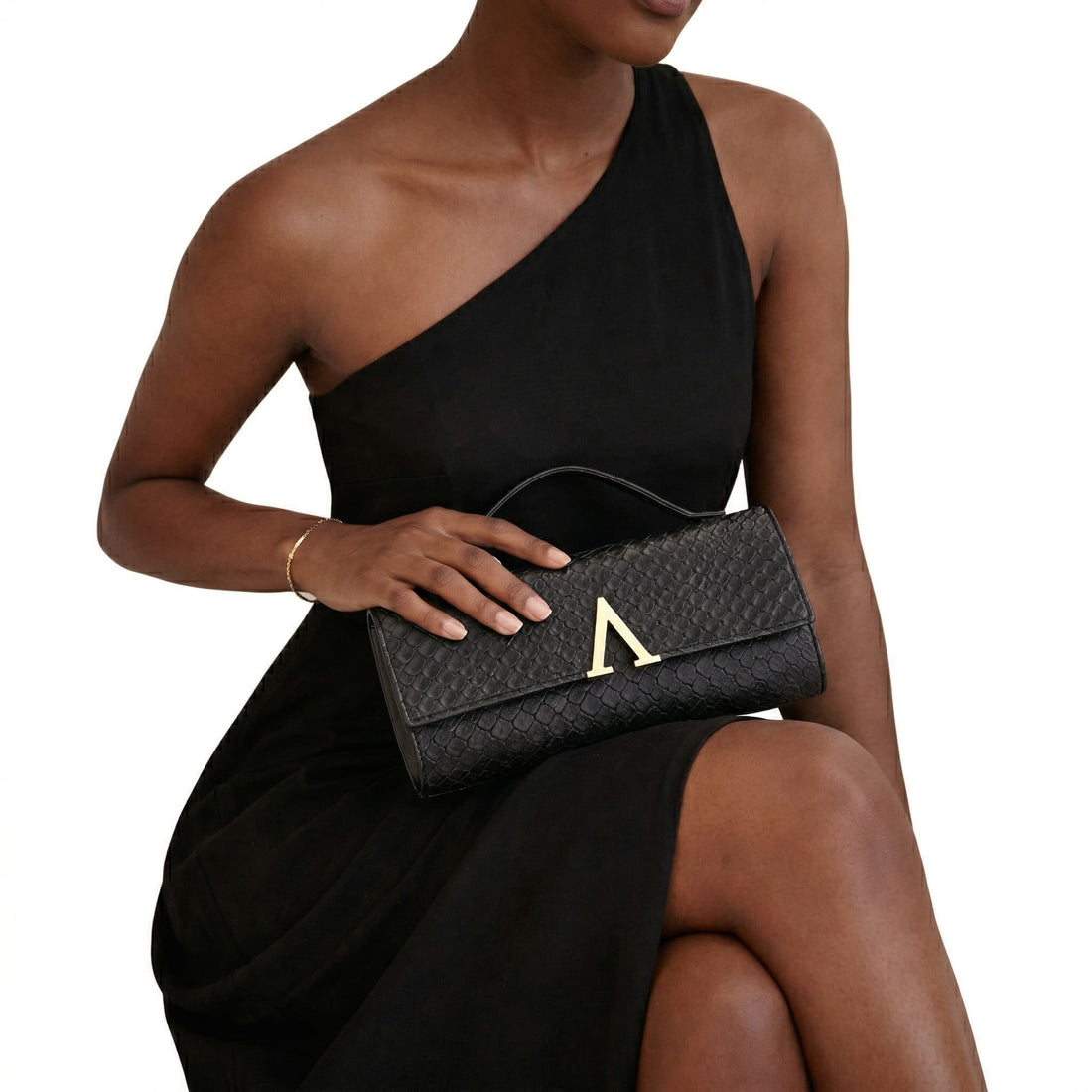 Elegant black textured evening clutch bag with gold Adedamola Atelier emblem - formal metallic handbag for weddings and galas | Edmonton Canada