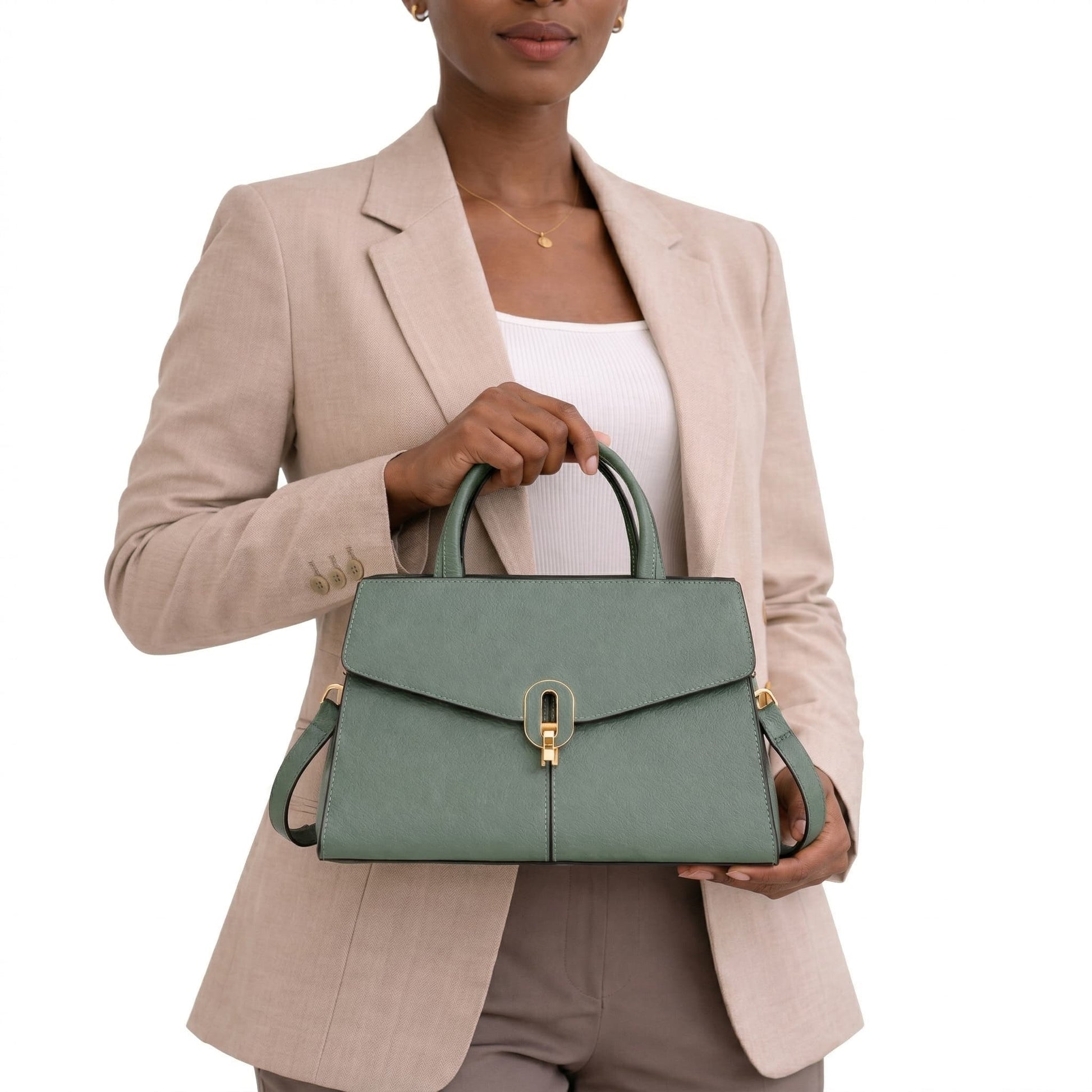 Person holding a green handbag against a white background