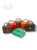Royale mini trunk bag collection by Adedamola Atelier – six structured vegan leather crossbody bags in brown, red, orange, green and black, Edmonton Canada