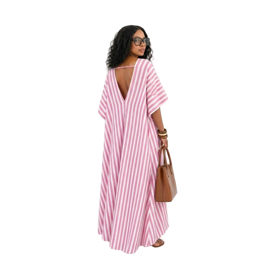 Woman wearing a pink and white striped dress holding a brown bag on a white background