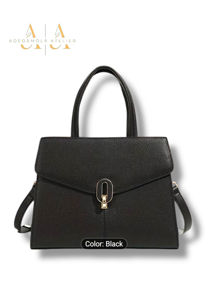 Black handbag with a silver clasp on a white background