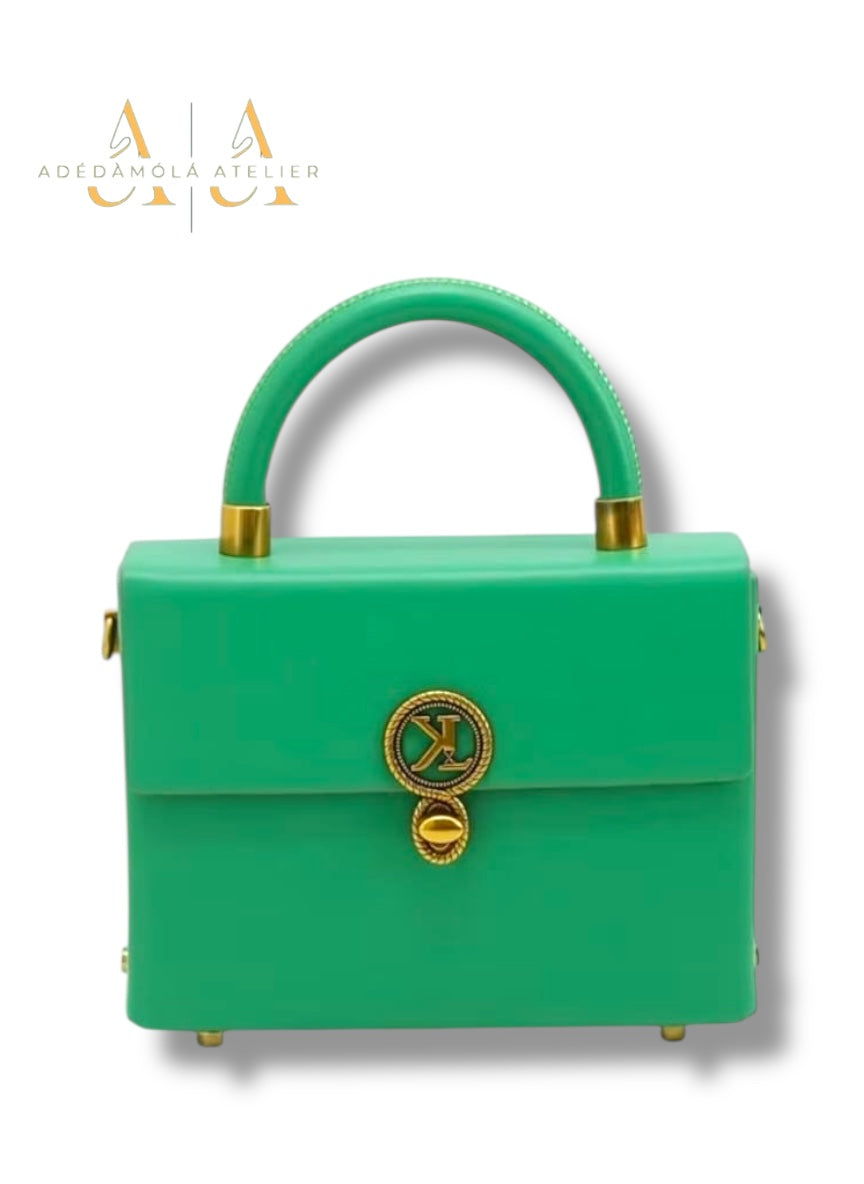 Brown handbag with gold accents on a white background