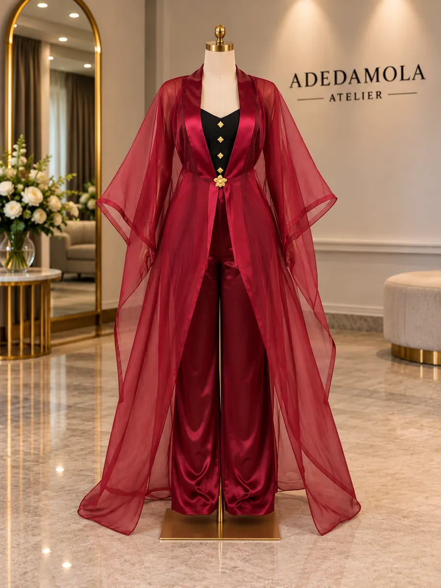 Full-length burgundy satin trouser set with a sheer flowing organza overlay
