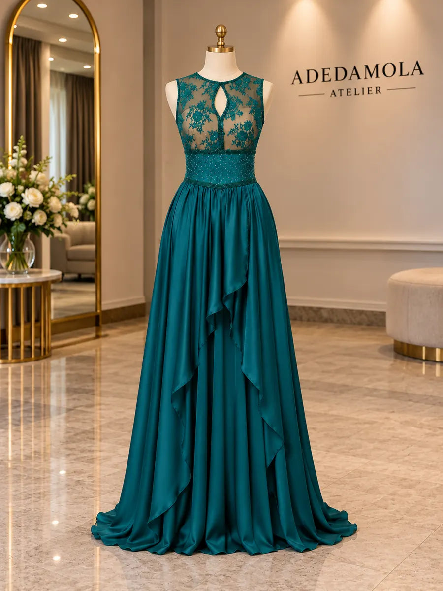 Full-length emerald green gown with sheer beaded bodice and handkerchief satin skirt