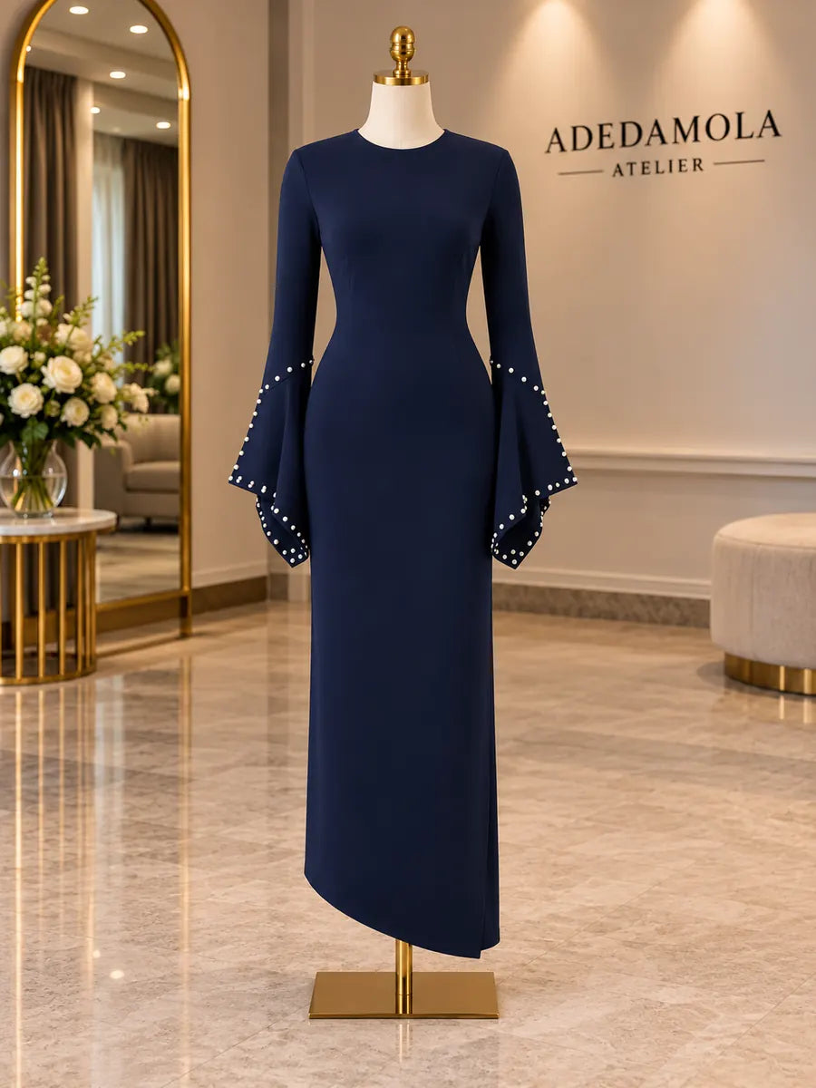 Full-length navy column dress with dramatic pearl-trimmed bell sleeves