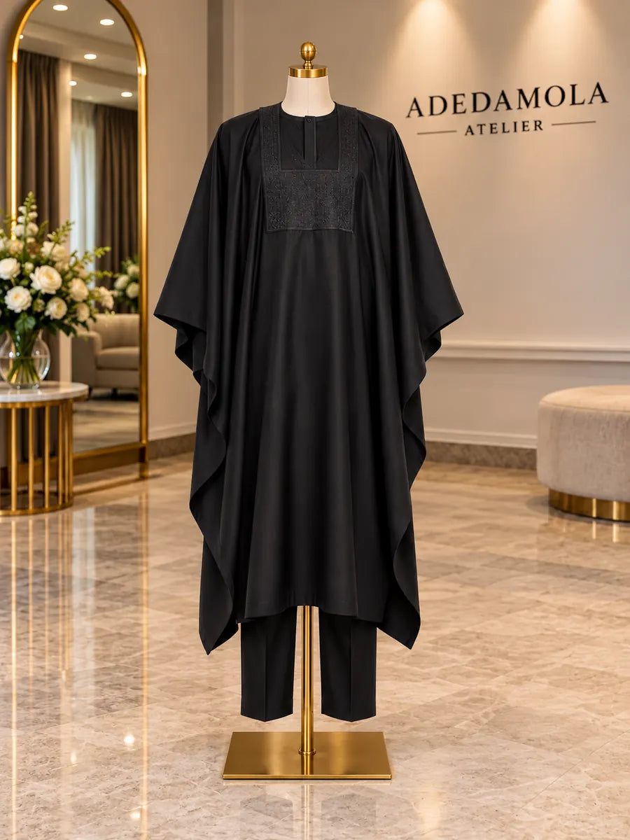Full-length black three-piece groom’s agbada with wide sleeves and tonal chest embroidery