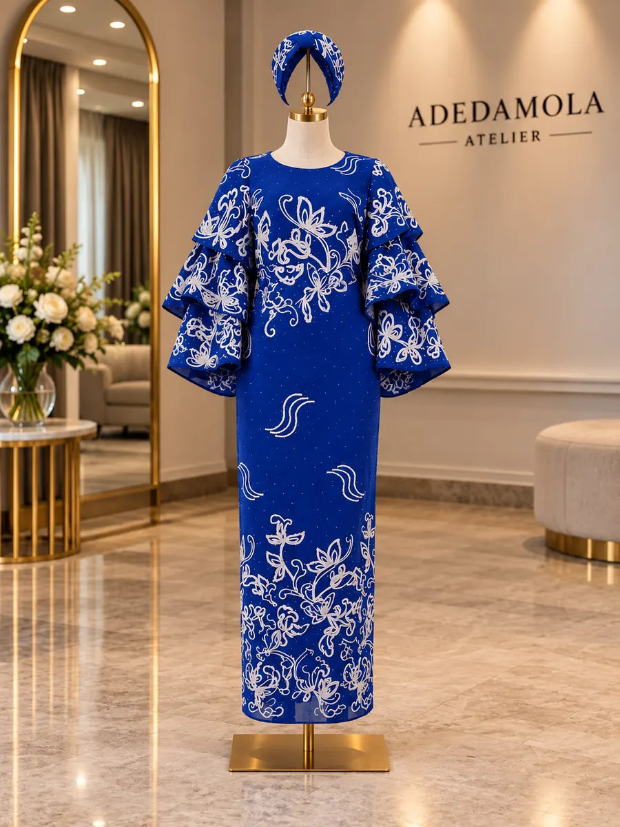 Full-length royal blue embellished column gown with tiered sleeves and matching gele