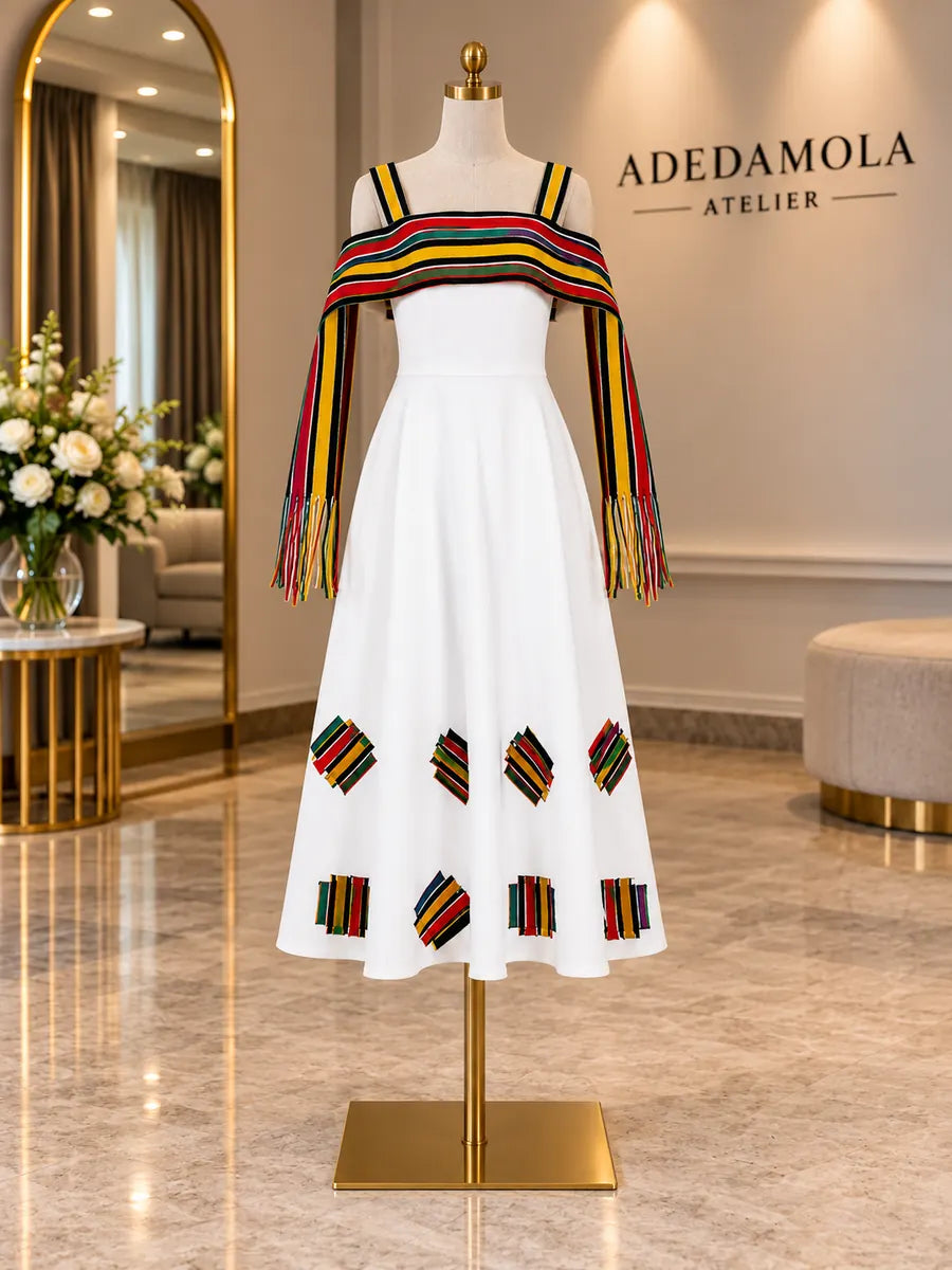 Full-length white dress with hand-loomed multicolour fringe wrap and geometric patches